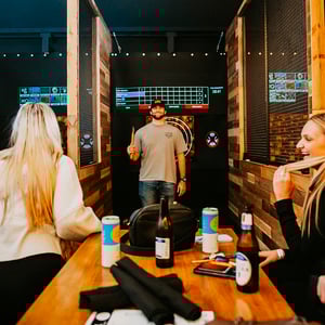 college students drinking and axe throwing together